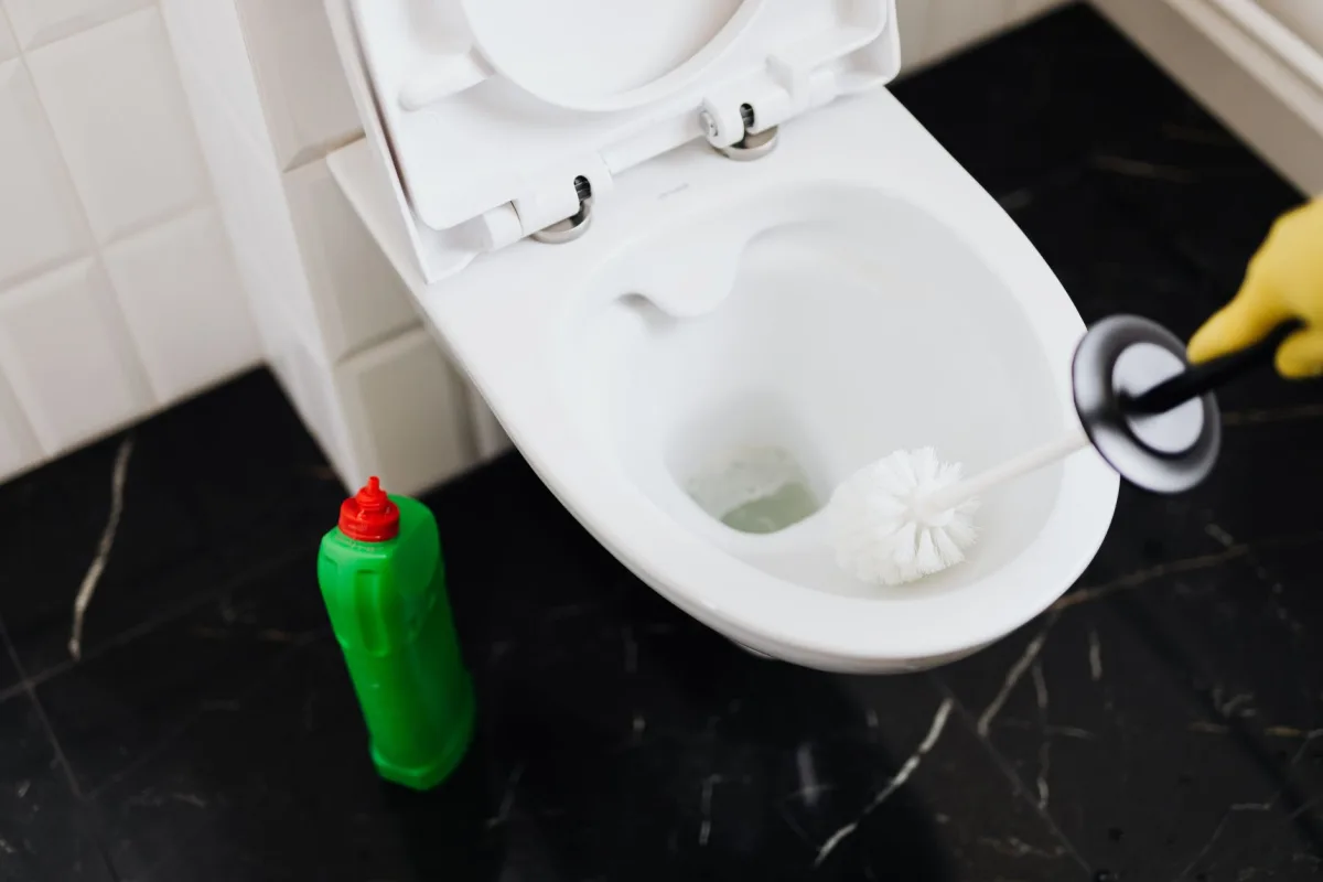 Homeowner using a plunger to clear a single clogged fixture drain