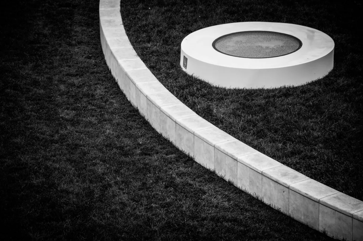Green plastic septic tank riser and lid brought up to ground level in a lawn
