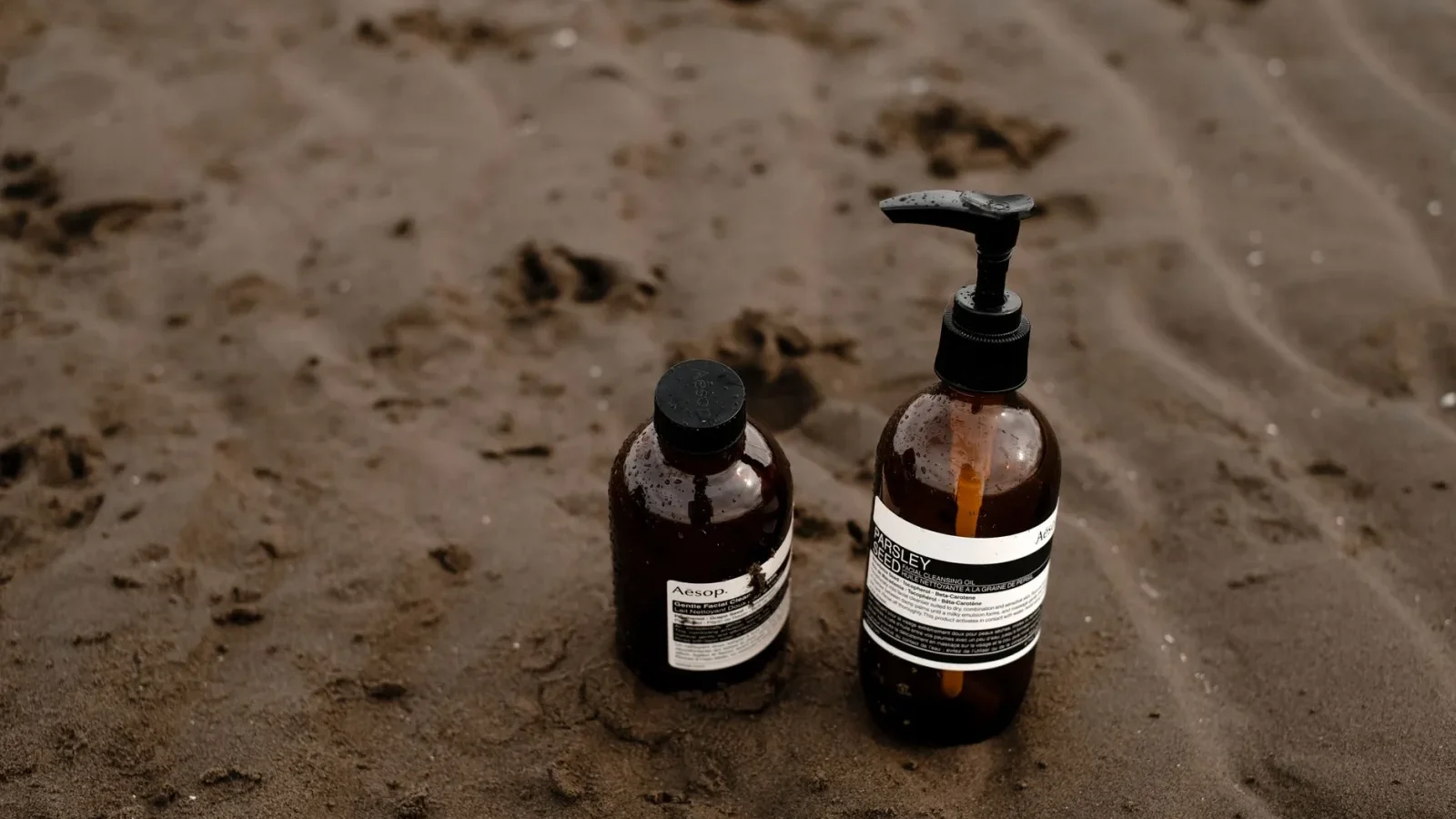 Two septic treatment bottles compared side by side on a store shelf