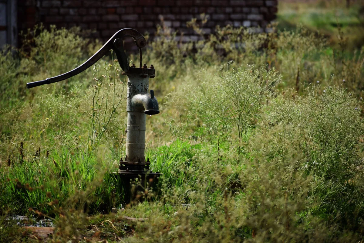 Septic technician pumping a home tank to reduce load on the drain field