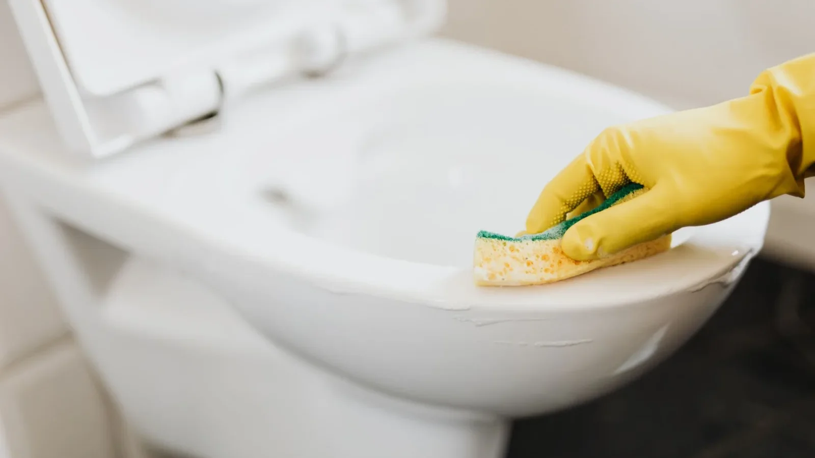 A package of flushable wipes sitting on a bathroom toilet tank lid