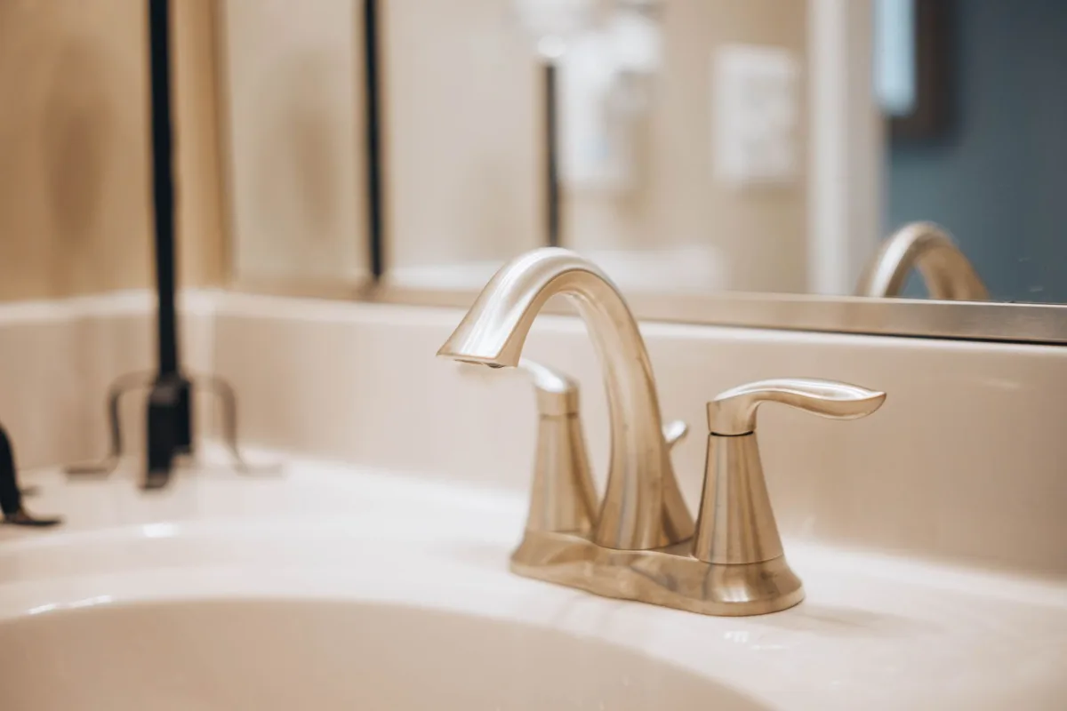 Open bathroom sink drain with the stopper removed for cleaning