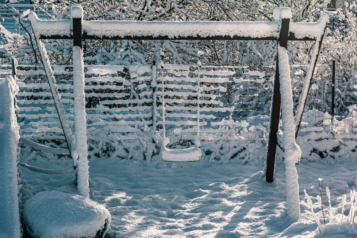 Snow covered backyard in winter with a buried septic system beneath