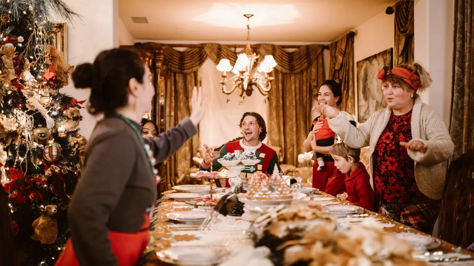 Full house of family and guests gathered around a holiday dinner table