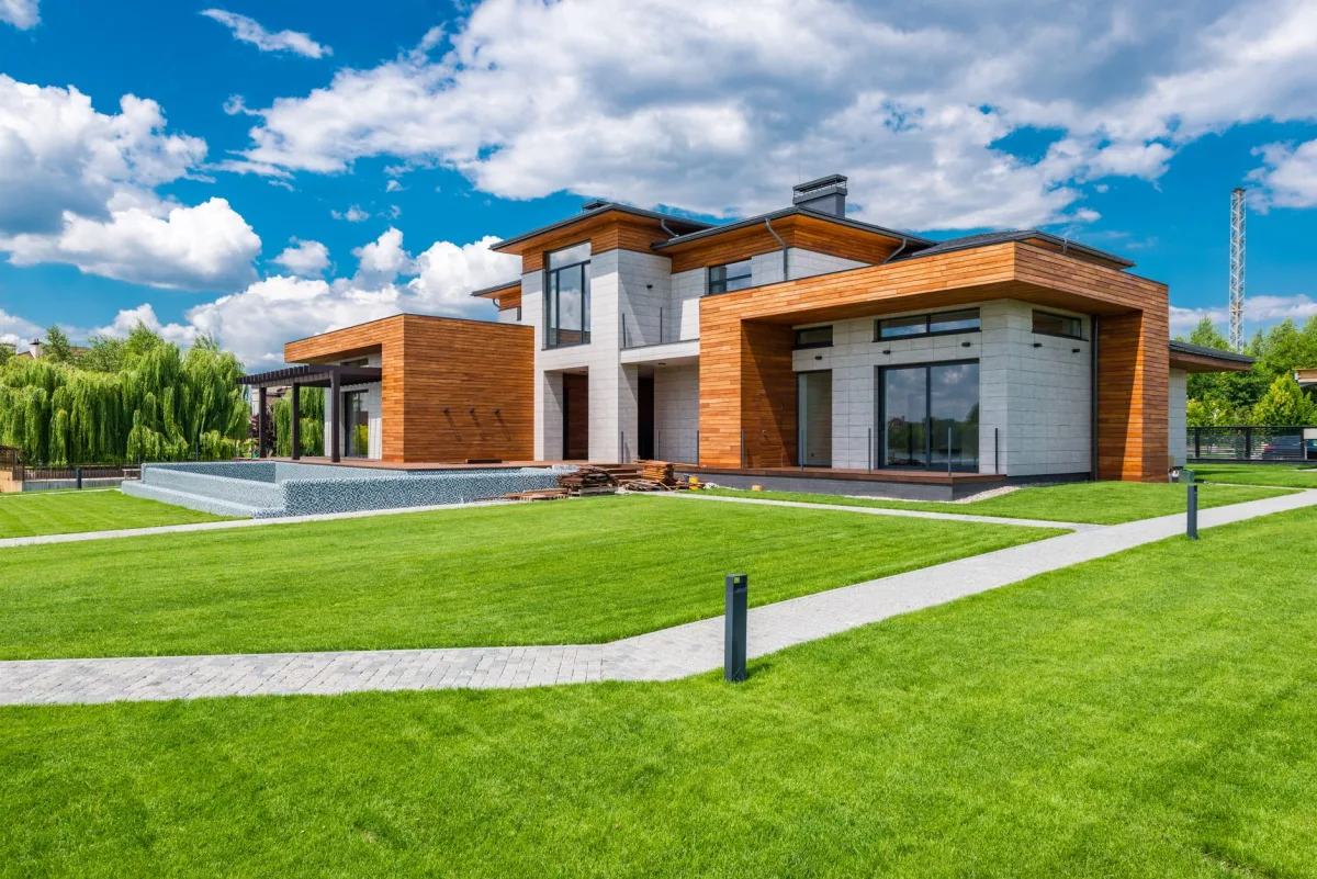 Homeowner walking across a green lawn over a septic drain field in spring