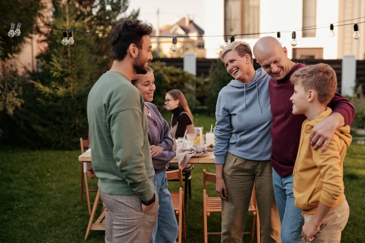 Group of guests gathered in a backyard during a summer holiday weekend