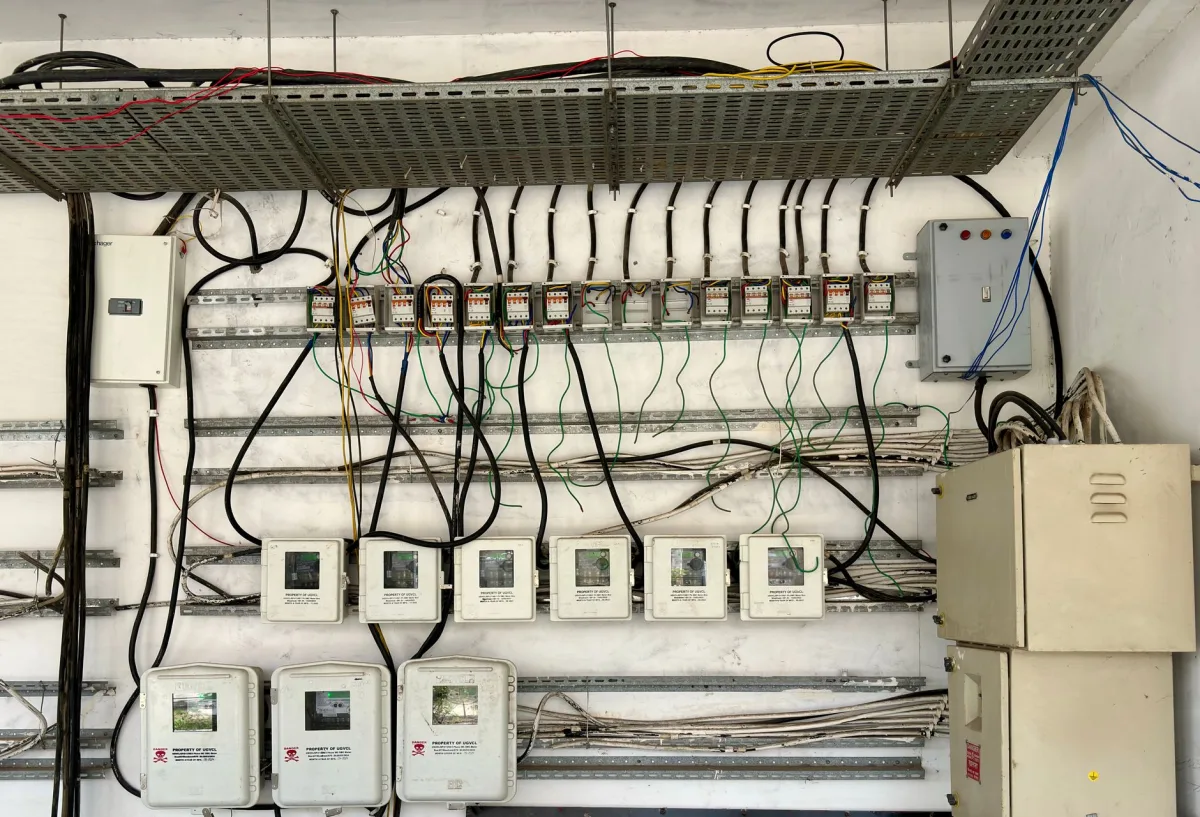 Homeowner checking a residential electrical breaker panel for a tripped breaker