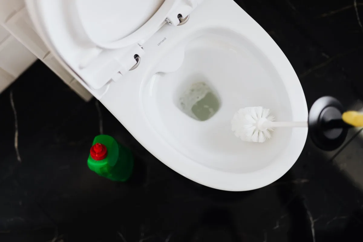 Open toilet tank showing a leaking flapper that wastes water