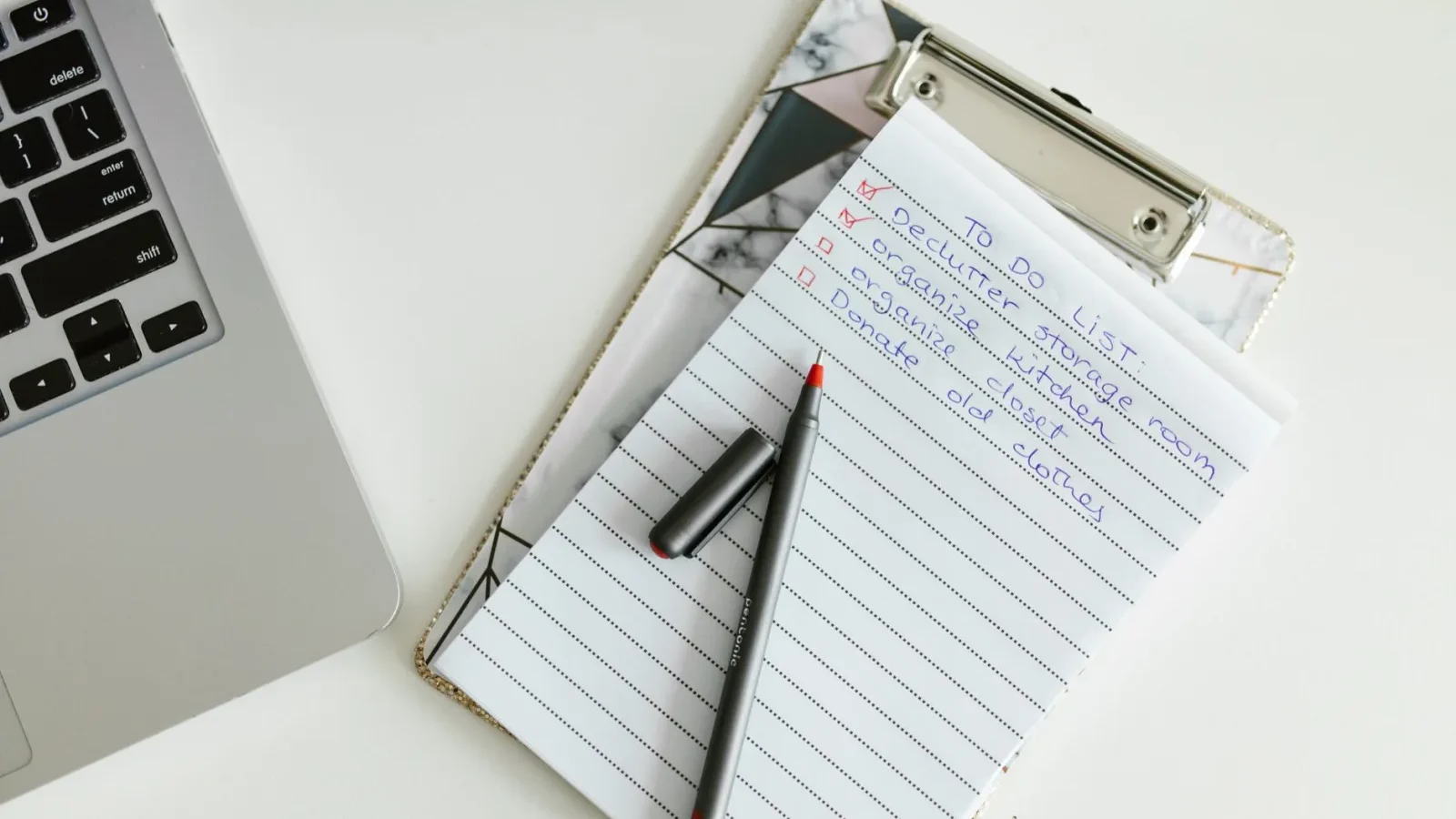Homeowner filling out a cost planning checklist on a clipboard at a kitchen table