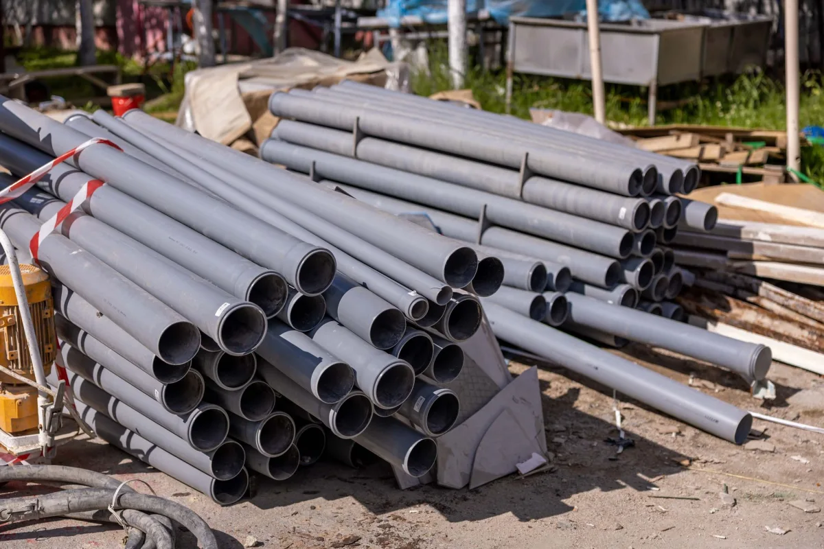 Perforated pipes laid in gravel-filled trenches during a septic drain field installation
