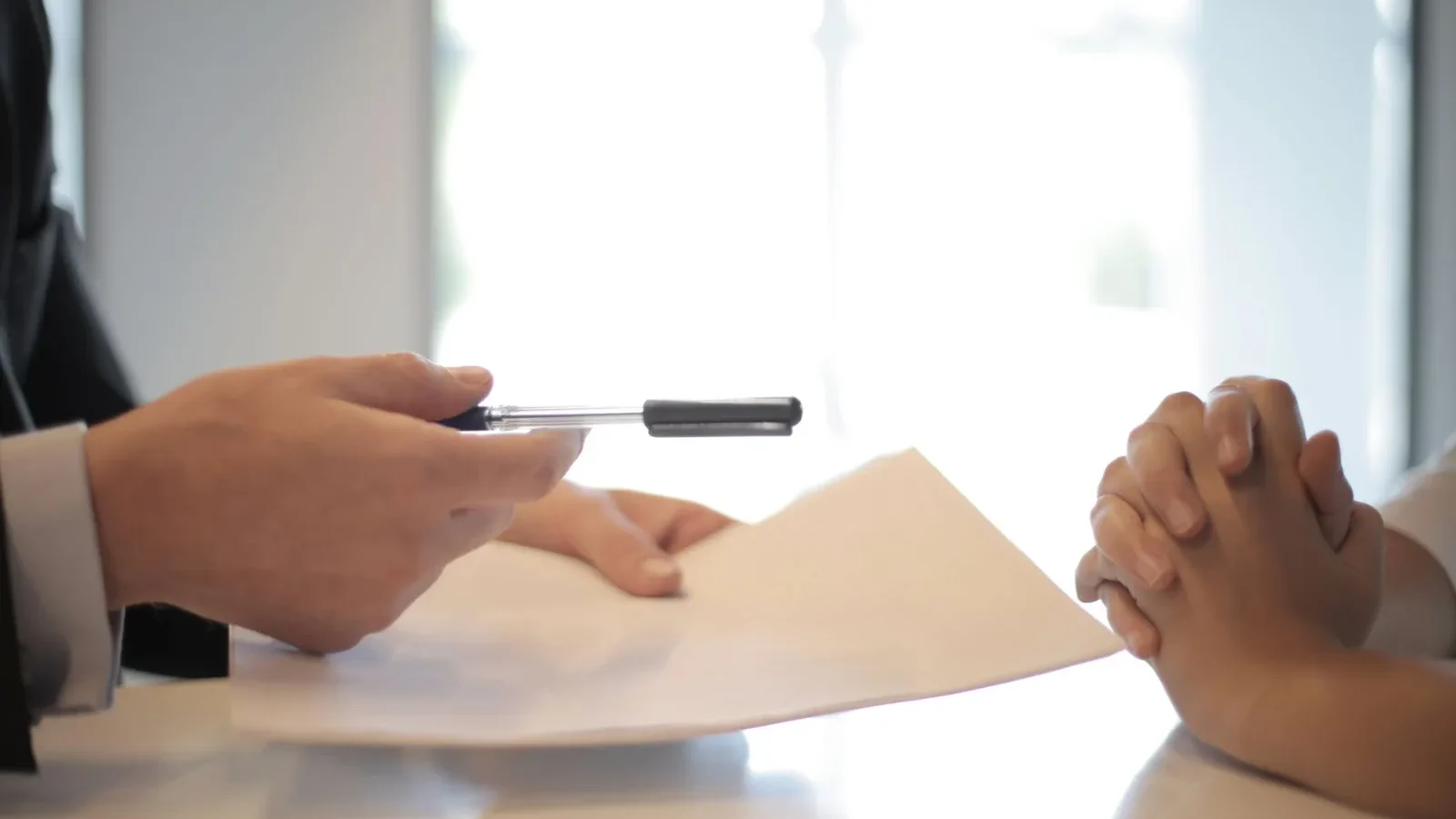 Homeowner reviewing financing paperwork at a kitchen table