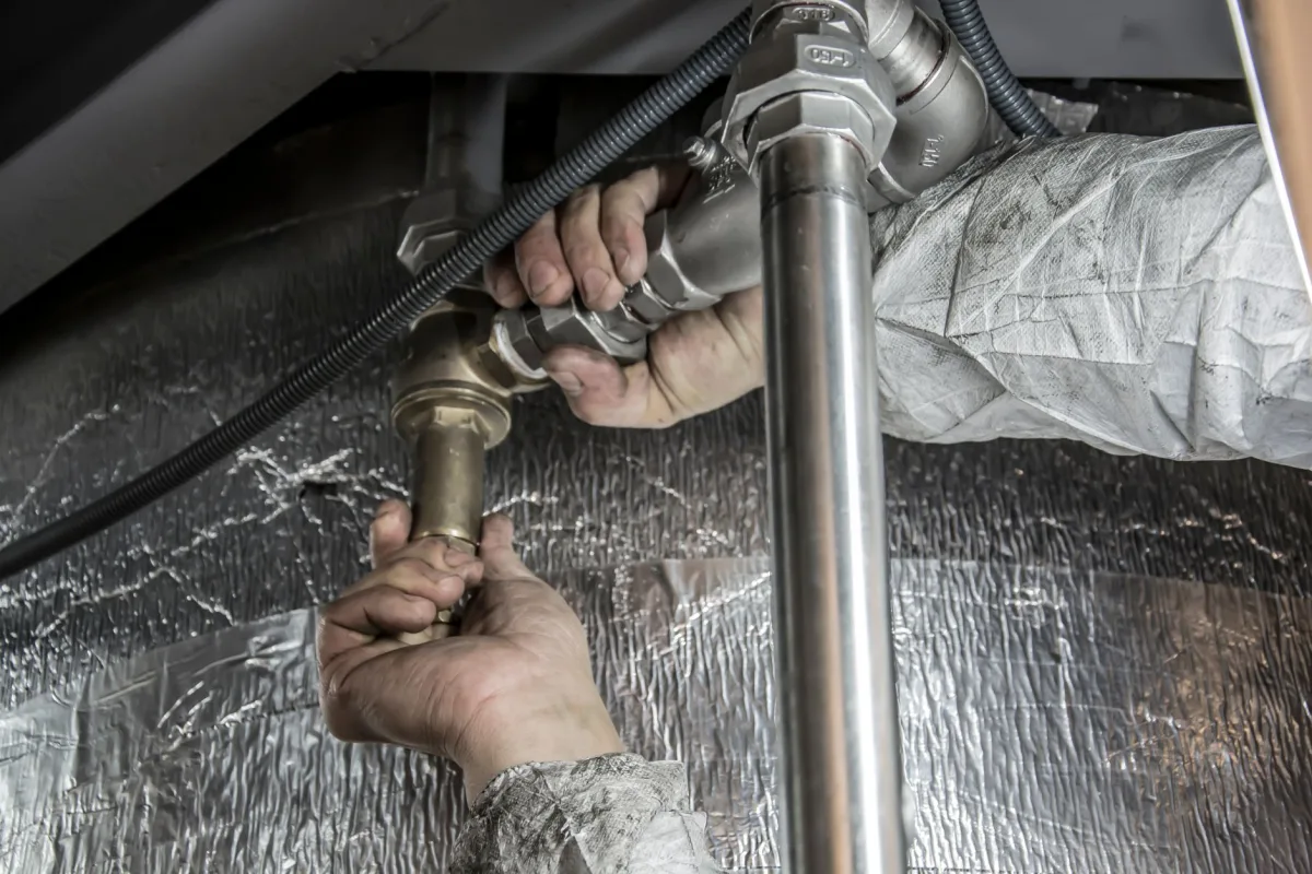 Septic technician checking the effluent filter during a routine inspection