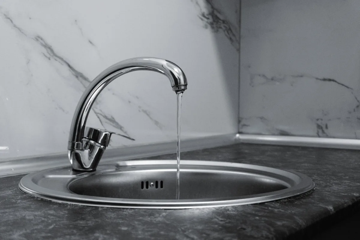 Water running from a modern low-flow kitchen faucet