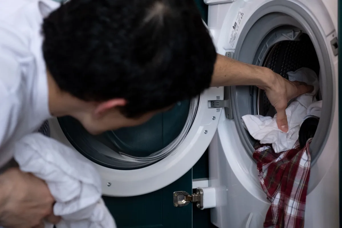 A home washing machine mid-cycle in a laundry room