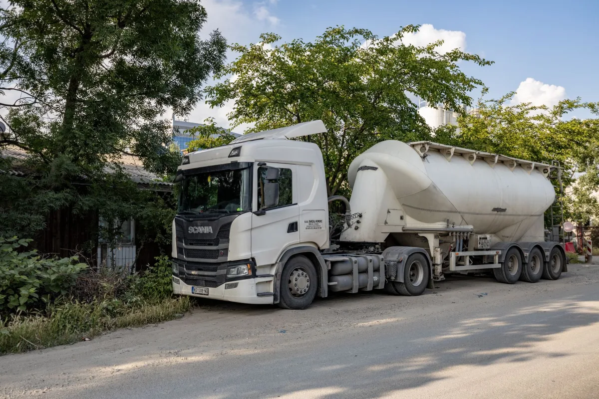 Septic pump truck servicing a residential tank