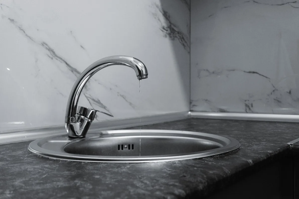 Water pooling in a kitchen sink from a slow drain caused by septic trouble