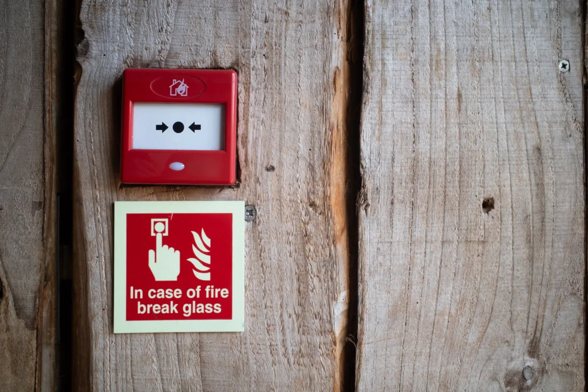 Red septic high water alarm panel mounted on an exterior house wall