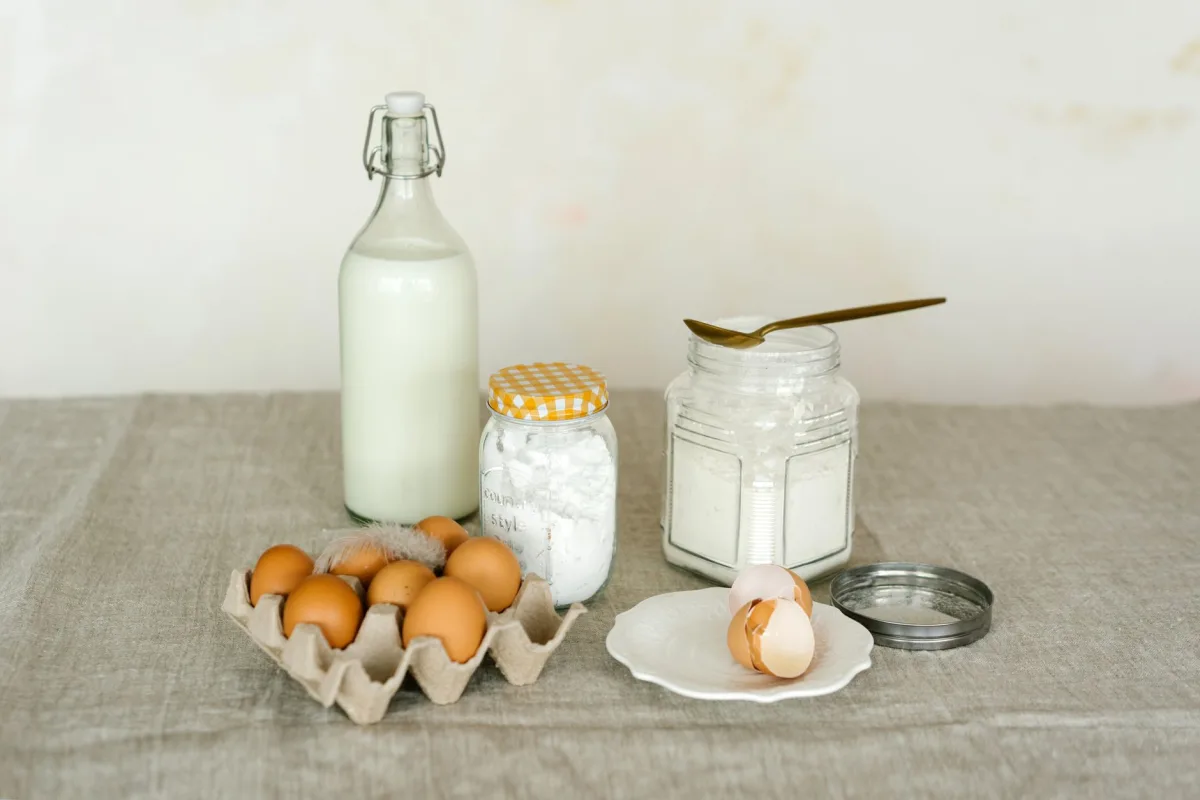 White vinegar and baking soda set out as gentle septic-safe cleaning ingredients