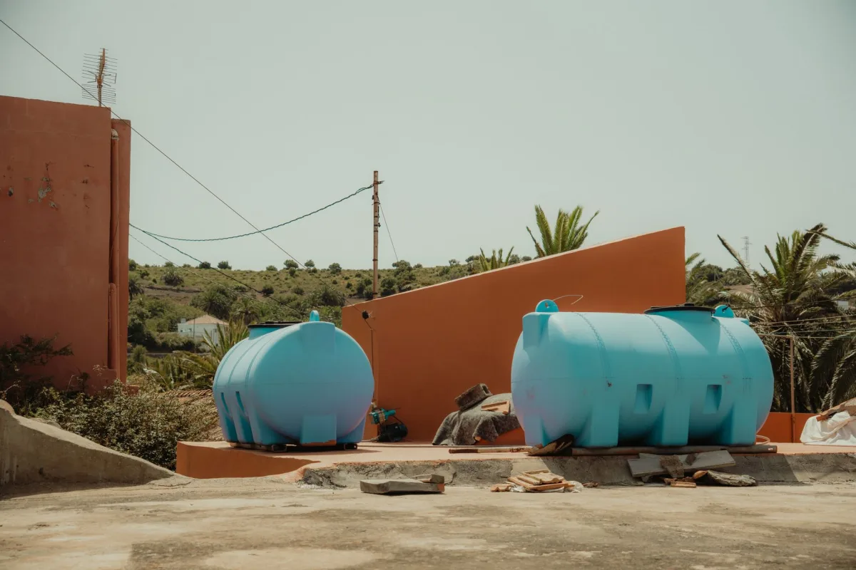 Open concrete septic tank showing inlet and outlet baffles inside