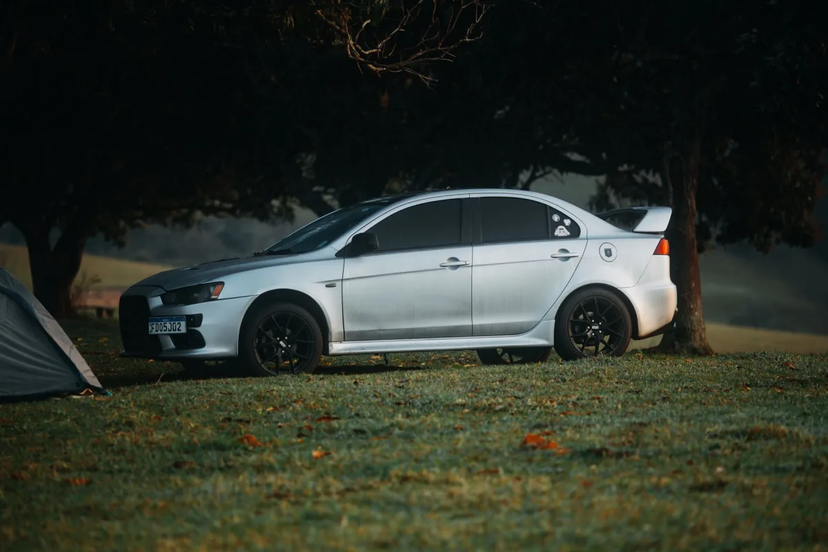 Car parked on a grassy backyard over a septic drain field