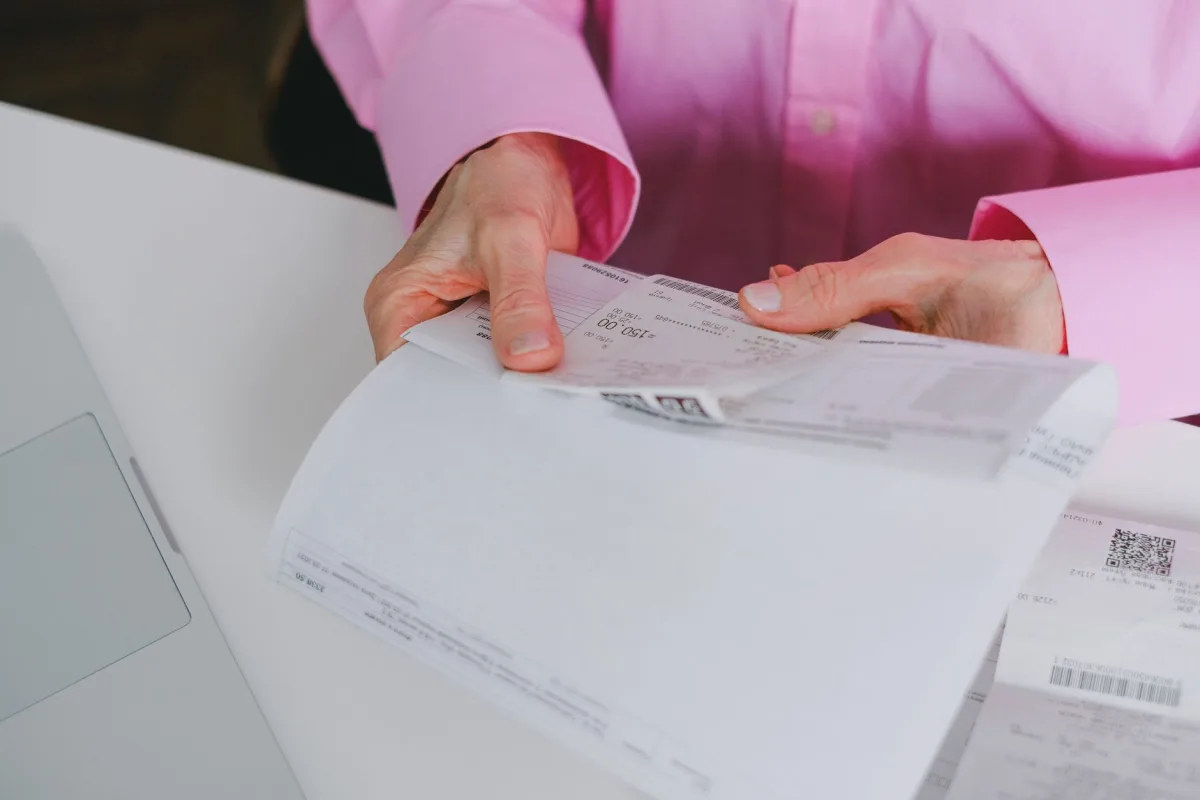 Homeowner reviewing a septic service invoice with a technician at the tank